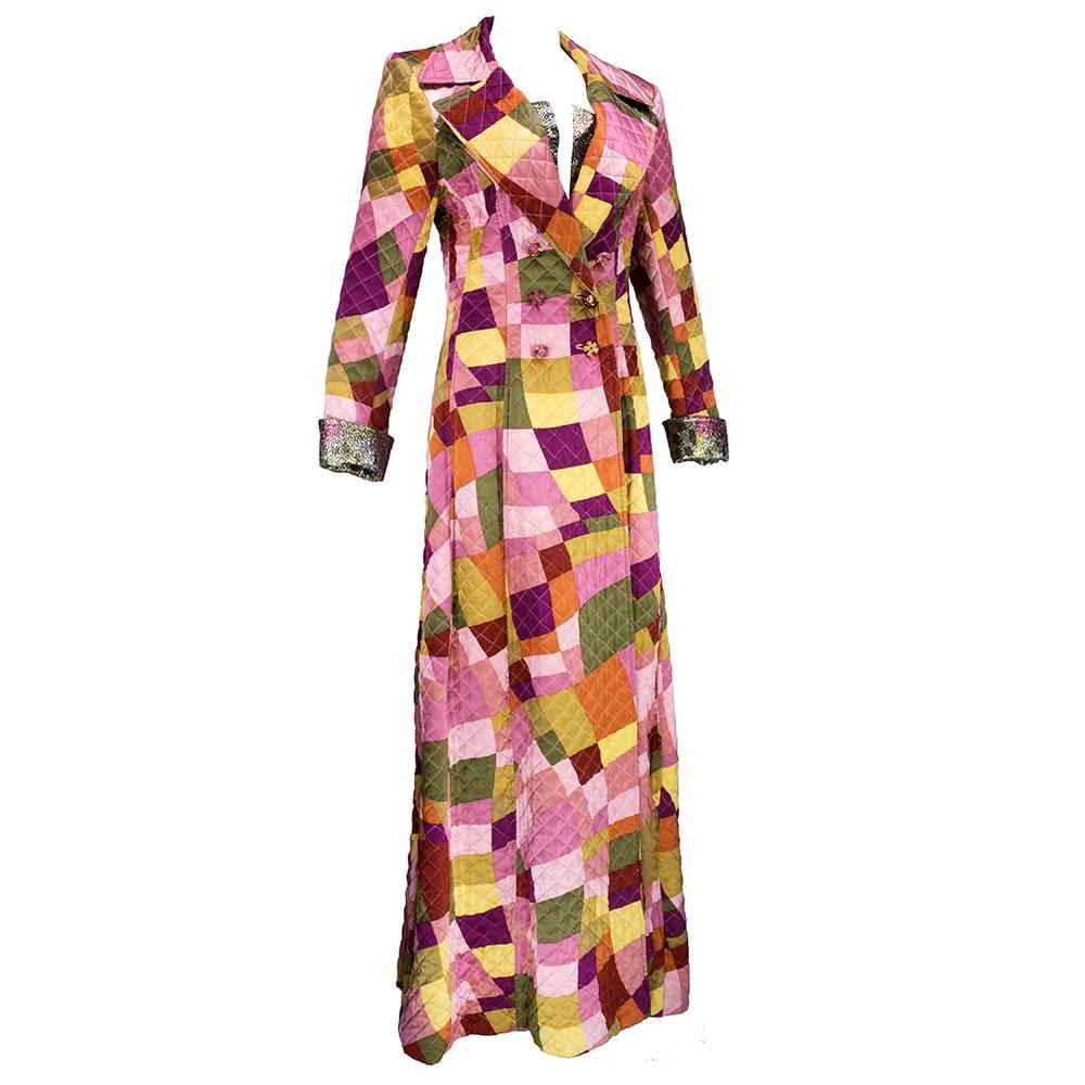 90s era maxi coat by genius designer Christian Lacroix. Quilted patchwork pattern in soft tones with mismatched buttons. Double breasted . Silk poly blend with lame accents. Boned to help maintain structure . Signature whimsical style. 