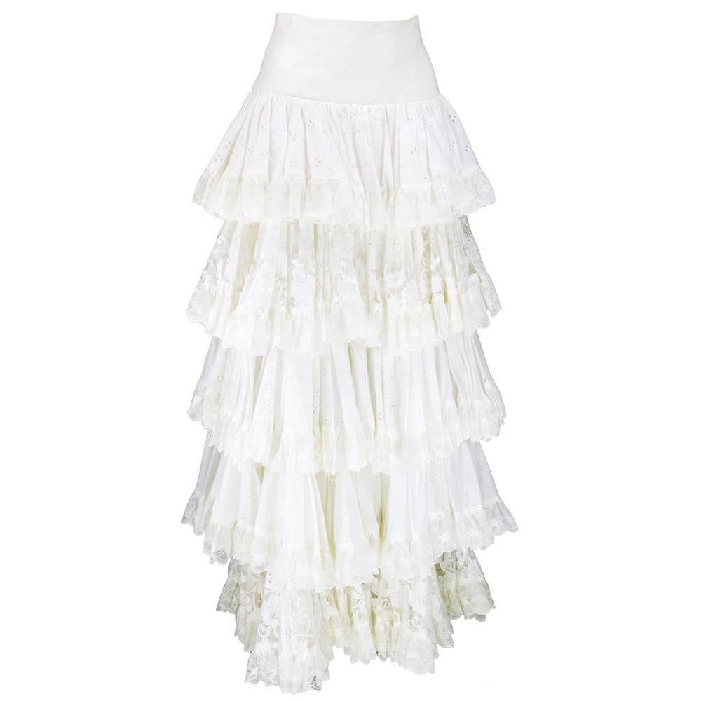 Super dramatic full length skirt by Dolce and Gabbana circa 1990s. Tiers of white cotton eyelet with ruffles - fitted to hip and flared tier by tier to floor. Fully lined. Great worn casually or  formal.