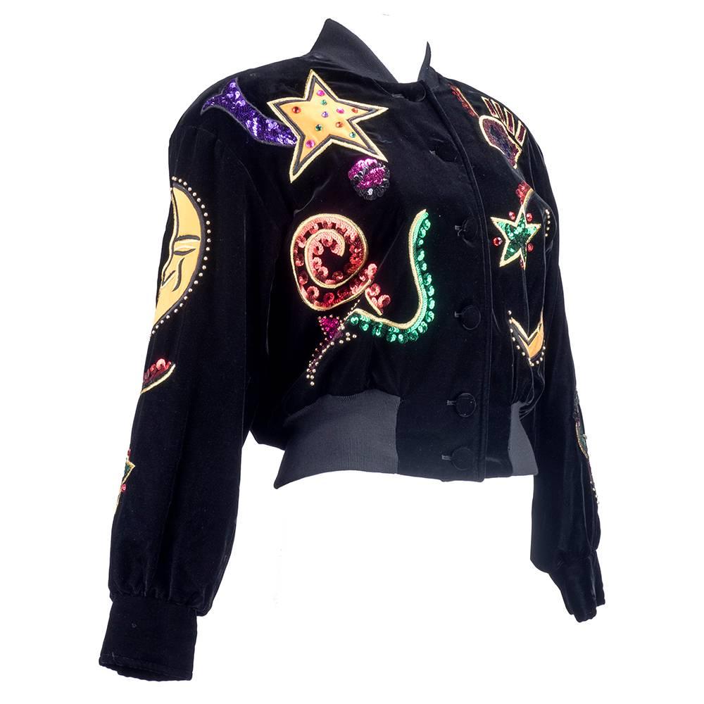 The most fun! 90s era black velvet  bomber style jacket by Escada. Moon and star theme. Quilted, rayon blend with mixed media applique with embroidery. Button front  and cuffs. Padded shoulder.