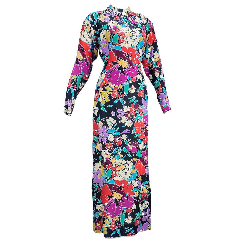 Body skimming full length sheath with high ruched neckline. Painterly colorful floral on black in a summer-weight cotton blend by great French designer Pauline Trigere.  Raglan sleeve with zippered cuff.  Fully lined. Accented with oversized
