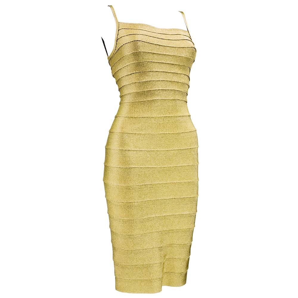 The queen of the body con dress by the late great Herve Leger. A couture gold lame bandage dress in a rayon/lycra/spandex blend. Individual bands carefully stitched together in a perfect  rows with military like precision. Iconic. Marked size Medium