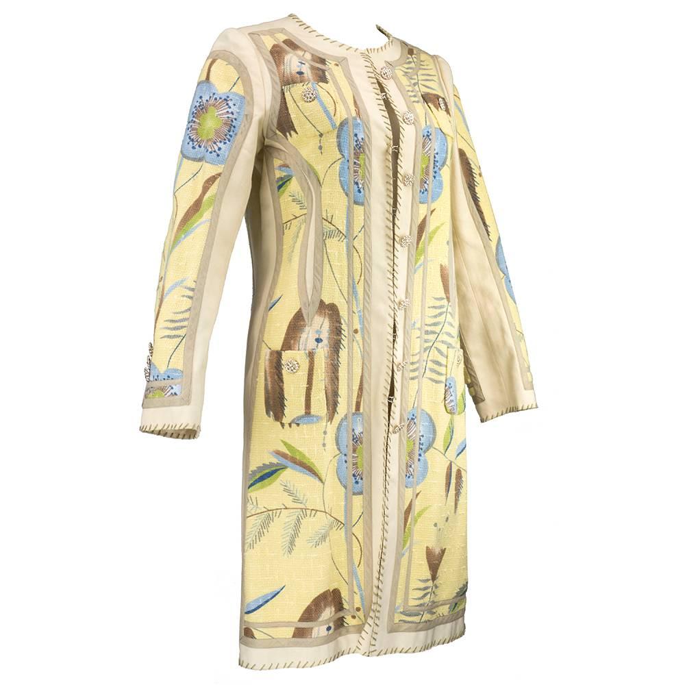Super fun, lightweight coat by Moschino circa 1990s. New with tags in nude tone with barkcloth floral panels. Faceted metal buttons and hook and eye closures down front. Unlined and great for cooler days in the summertime.
