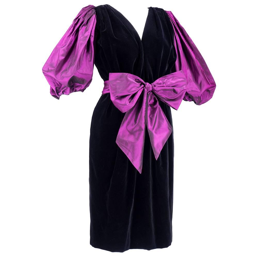 A classic design from Yves saint Laurent - lush black cotton velvet open to waist with gathered waist. Oversized pouf sleeves in iridescent eggplant taffeta and matching oversized sash belt that can bow at front or rear.  Drop dead chic.  Fire.