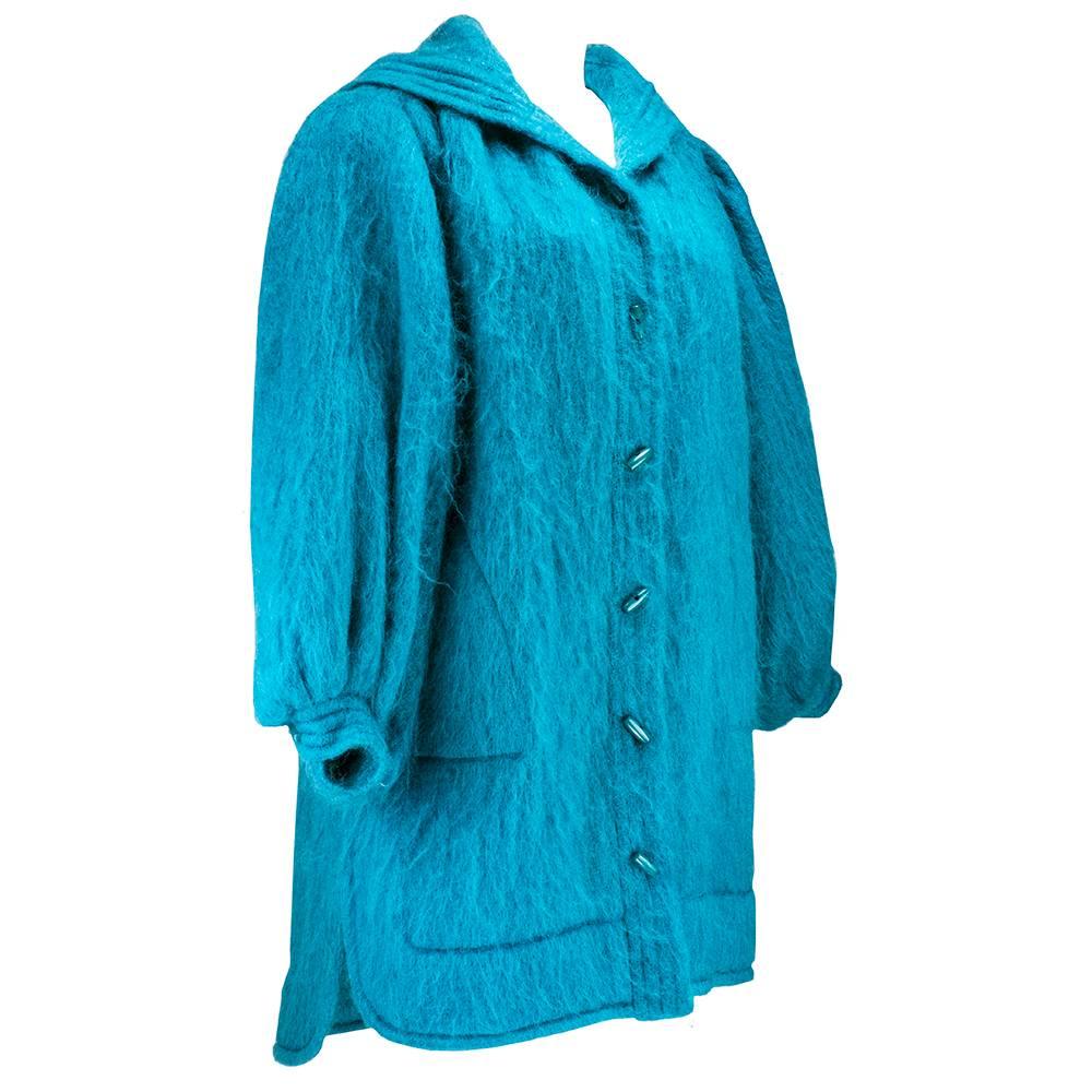Funky, fun and cozy coat by Yves Saint Laurent circa 1980s.  Blue turquoise mohair oversize car coat. Unlined with toggle buttons and hood. Puffy sleeves and large hidden pockets. 