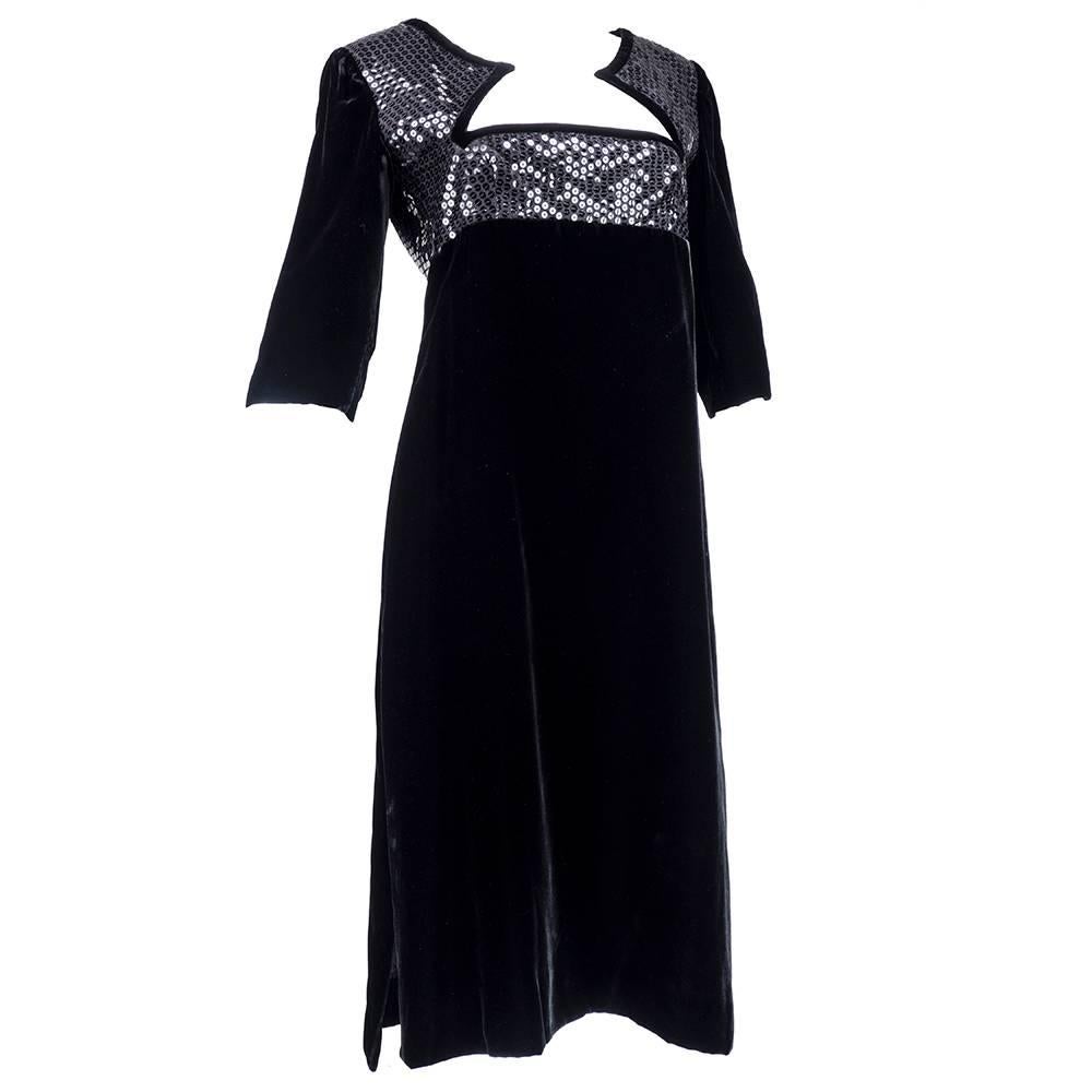 1980s Courreges dress in black velvet with sequin encrusted empire bodice. Interestingly cut neckline with three quarter sleeves. Fully lined in silk. Tea length.