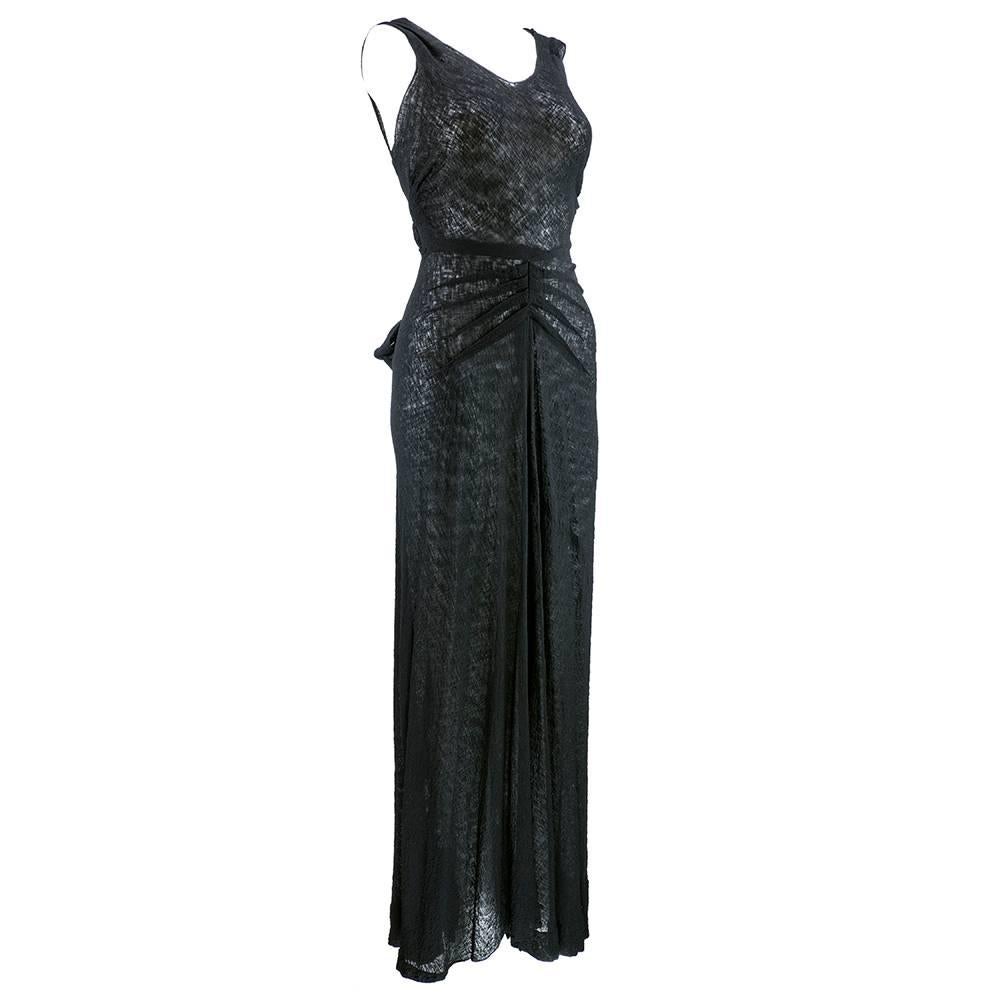 Slinky and sexy black bias cut gown from the 1930s. Lightweight, textured crepe. Interesting pleating detail at waist.  Long sashes extend rom back can be draped, wrapped or trailed. The older, more sophisticated cousin of the little black dress.