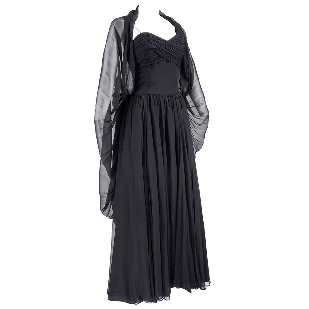 Classic 1950s drop dead gorgeous glamour gown by American designer Frank Starr.  Voluminous full length skirt. Ruched at bust line with boned bodice.  Fully lined. Attached swag cascades down back from waist -  or can be worn over shoulders as cape