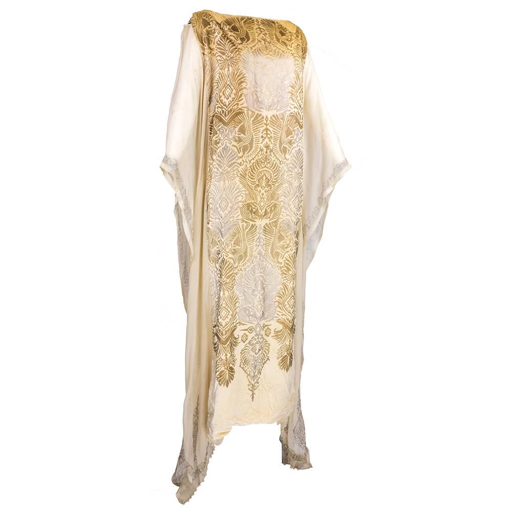 Rare and majestic piece by important early 20th century designer Maria Monaci Gallenga, a contemporary of Fortuny. Circa 1920s Ivory velvet full length tunic with panels of chiffon cascading to floor. Stencilled in classic style in gold and silver. 