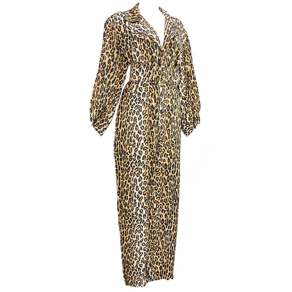 From beloved American designer and fashion icon Patrick Kelly. Whimsical one piece jumpsuit in leopard print in cotton blend. Oversized with exaggerated details. Unlined with lightly padded shoulders and oversized belt.  Wide legged pants with