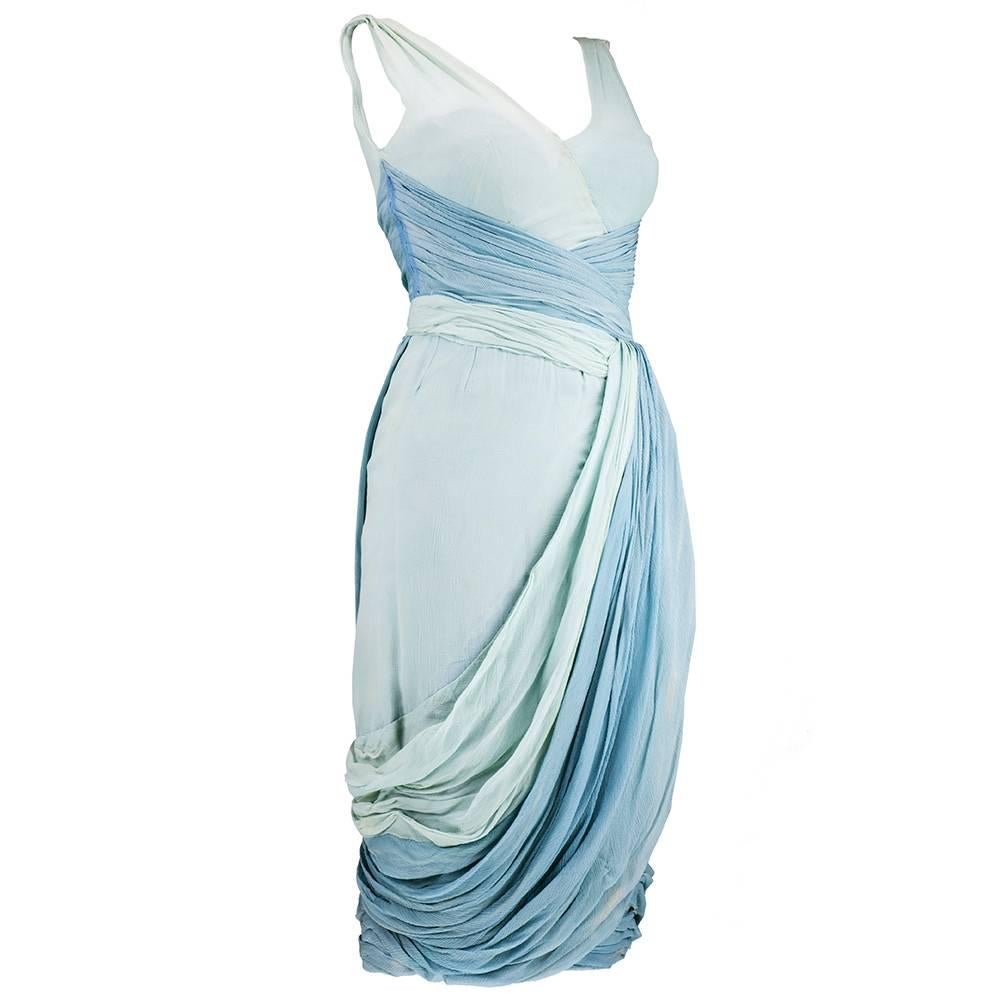A Jean Desses draped chiffon cocktail gown, late 1950s, bearing Paris pret a porter label and Canadian retail label, in 3 colors starting with aqua and moving to pale blue, giving the impression of ombré.   This classicly draped Desses dress has a