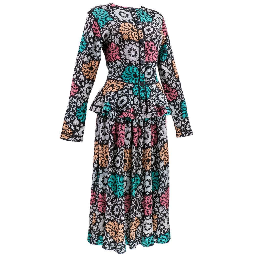 Exuberant, stylized floral printed ensemble by the house of Missoni circa 1980s. Button front top can be worn as blouse or jacket. Fitted to waist with flared peplum, with a full skirt.

Skirt–
Waist:  27