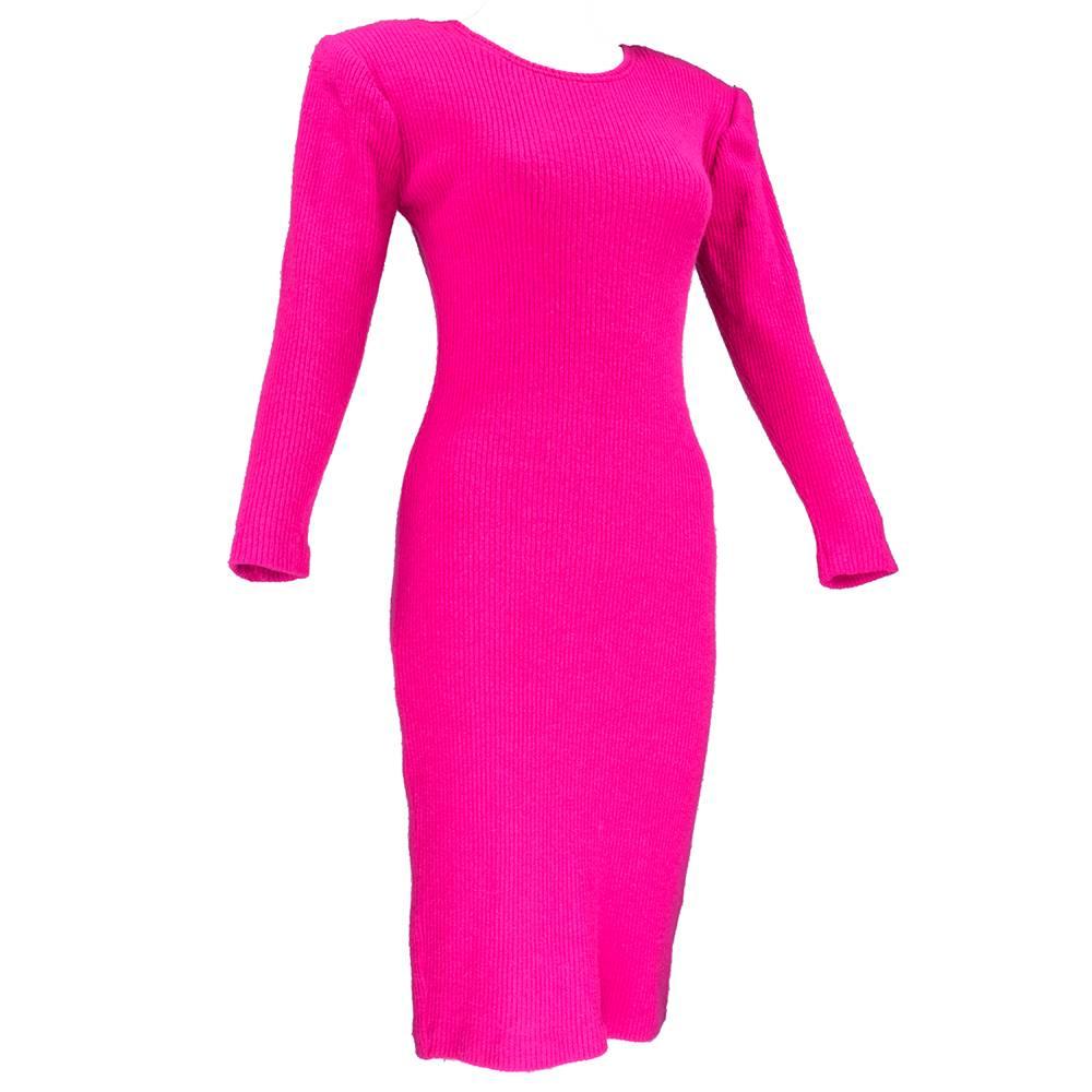A Patrick Kelly staple. A 80s era hot pink knit sheath - long sleeve, knee length with low cut back. Sharp, padded shoulders. Curve hugging silhouette. Unlined. Sizing super flexible due to stretch in fabric -  measured flat.