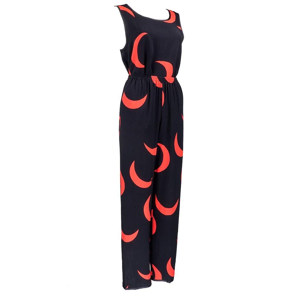 

Iconic print by YSL for Rive Gauche  circa 1970s. Black and red crescent moon print on 100% rayon shell top and loose fitting pajama style pants. Elasticized waist on pant. Great summer weight ensemble. Can be worn casual or dressy.

Pant