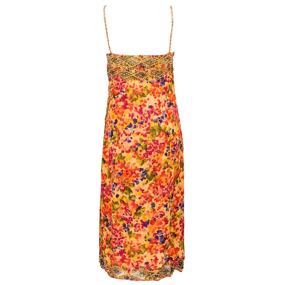 1980s James Galanos cocktail dress trimmed with embroidery and beads.  Silk watercolor floral print in autumnal colors. Thin spaghetti straps with wrap front detail. Lovely lightweight summer party dress.