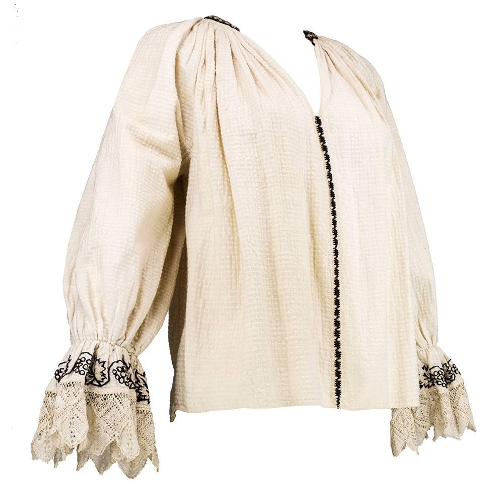 Eastern European - possibly Romanian in origin - a beautifully crafted blouse in heavy, textured cotton with intricate embroidery and delicate crochet. Gathered  at wrist with flared, crochet cuffs. Collar ringed in gold bullion trim. Slight