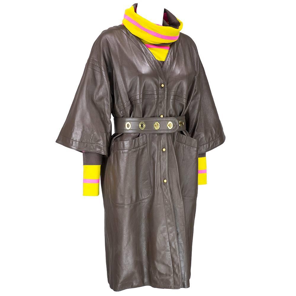 From the great American designer Bonnie Cashin - one of her classic ensembles consisting of a brightly colored striped jersey dress with cowled neck that could become a hood with a coordinating chocolate brown leather coat. Coat has matching belt