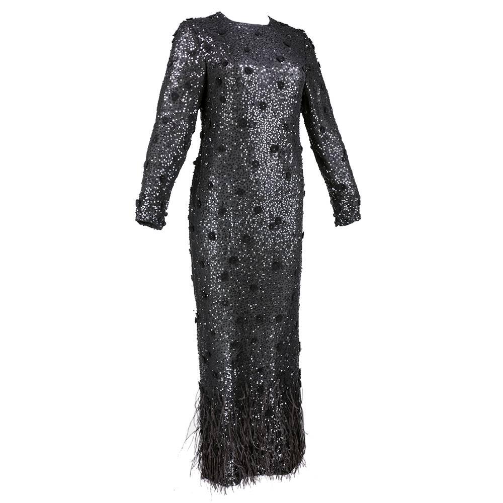 Somehow demure but still sexy - a full length sheath style gown by great American designer Bill Blass. A classic look from the iconic designer.  Sheer, lightweight silk - lined - festooned with sequins, appliqued flowers and trimmed at the hem with