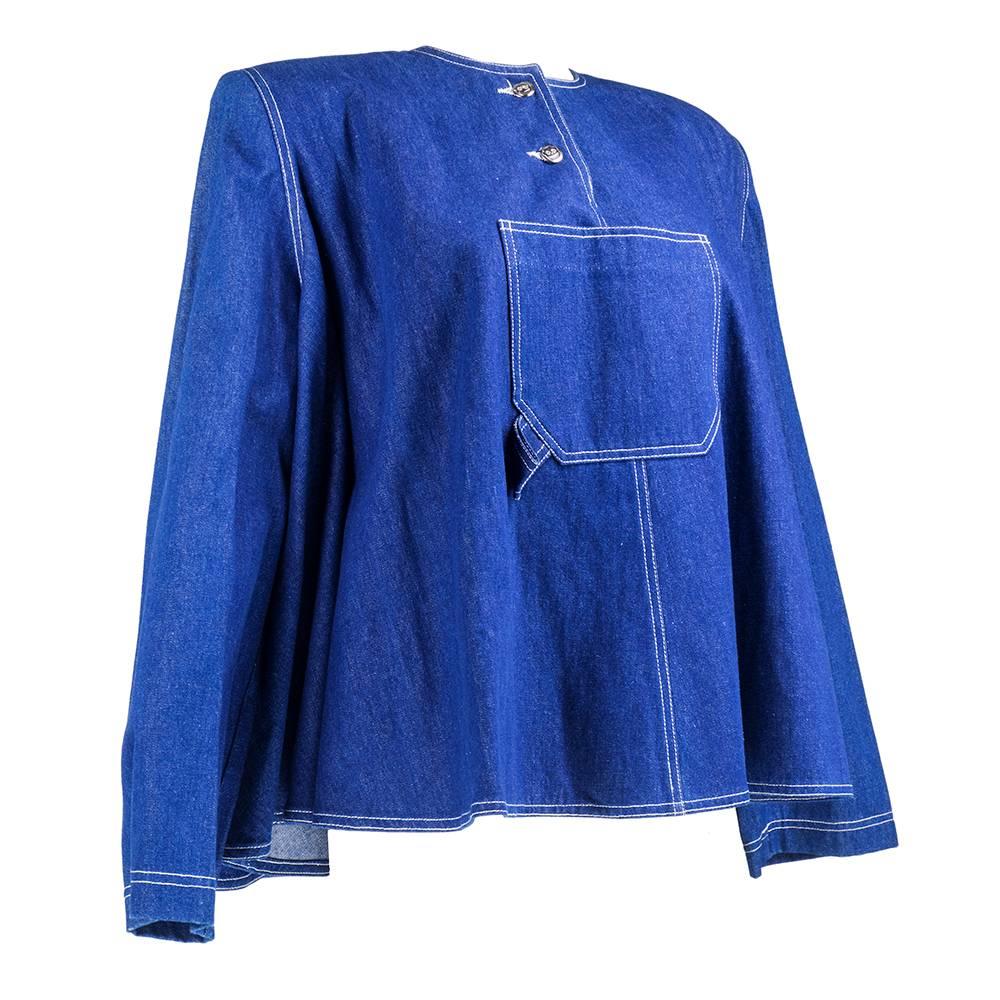 From the late great American Ex pat designer Patrick Kelly. Crisp blue denim poncho style top. Oversize pocket front and center with two button opening at collar with signature logo. 100% cotton. Unlined and never worn.