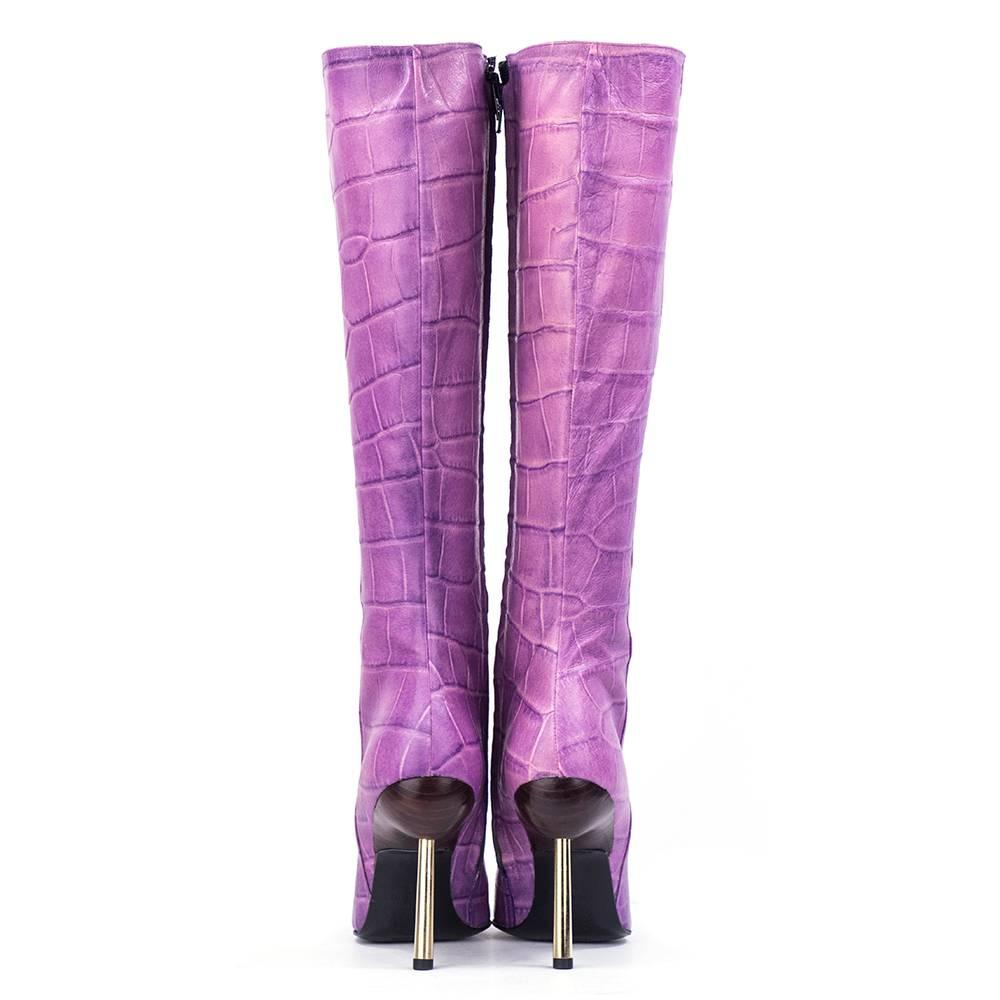 Lifetime Versace boots in leather. Knee high in soft purple embossed in a mock croc pattern . Wood insert  at heel adds interesting focal point to stiletto heel.  Modern toe - zips up inner calf. Gold-tone spike metal heel. Labelled Gianni Versace