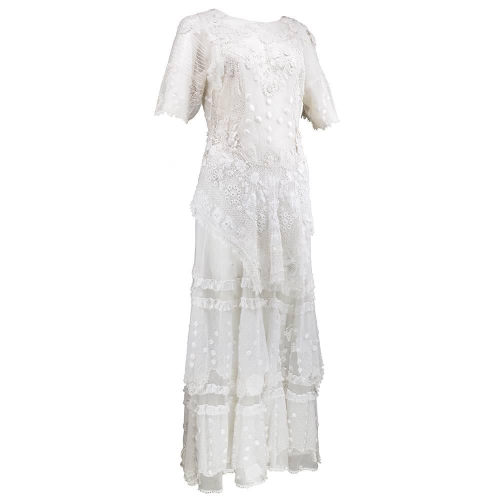 Beautifully pieced together Edwardian style full length dress made with antique laces and other embellished textiles. Zips down back. Attached peplum with full length skirt. Sheer and unlined. Wonderful piece for a bride. Small pinholes and