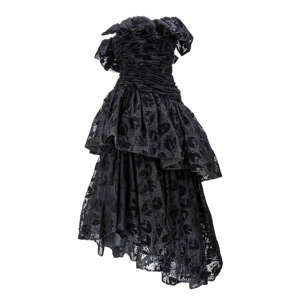 Incredibly dramatic evening gown - perfect for any gala. By the late, great Arnold Scaasi. Black flocked strapless gown with asymmetrical tiered full skirt, backed in black tulle and edged with horsehair. Fully ruched bodice and completely lined.