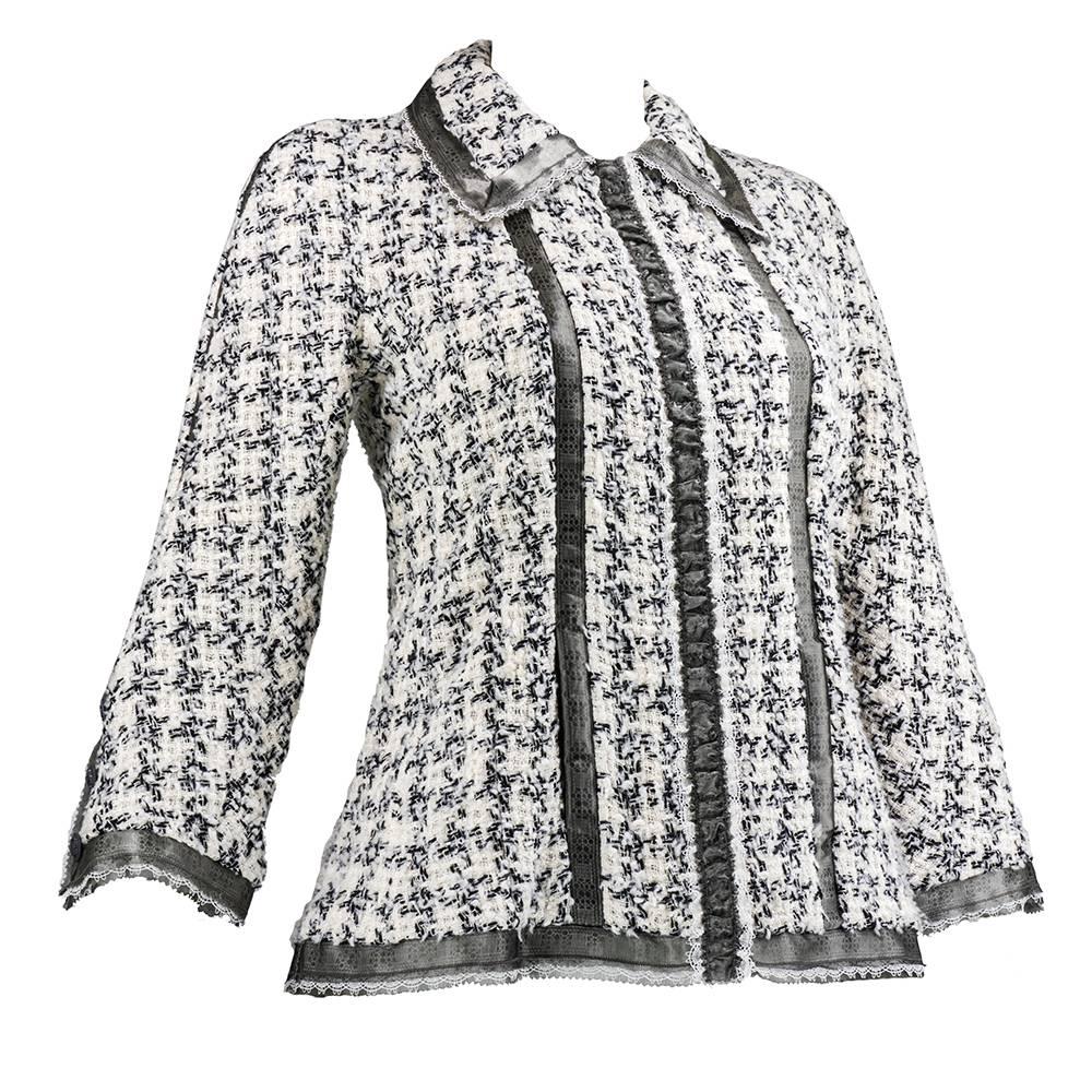 A modern take on a fashion classic - the new and improved little Chanel jacket circa 21st century. Black and white tweed with trim in a nubby plaid pattern. Trimmed in delicate lace with cropped sleeves and grey sheer trim. Hidden zip front with