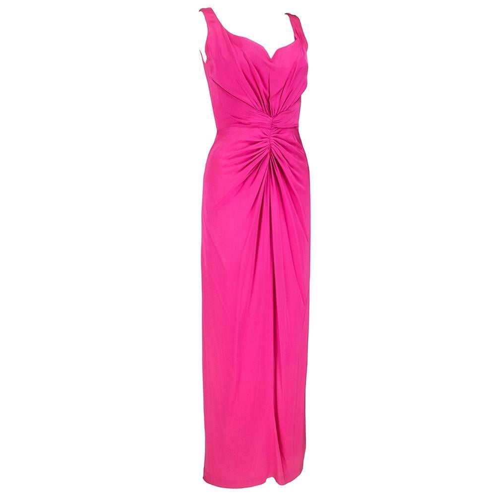 Gorgeous hot pink silk crepe gown from Valentino features radiating pleats from the waist in the style of a Roman goddess. Bodice has an elegant, sculpted sweetheart neckline reminiscent of Grace Kelly. Fully lined, zip back. 
