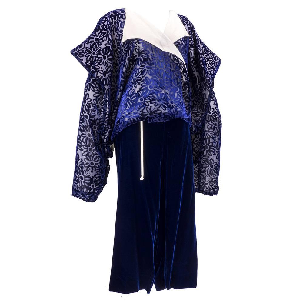 Two piece ensemble by Japanese design house Comme des Garcons. Dated 1996.  Rayon blend cut velvet kimono style open front jacket with floral motif.  Lined in a fabric that feels like cotton but is listed as polyester.  With matching drawstring,