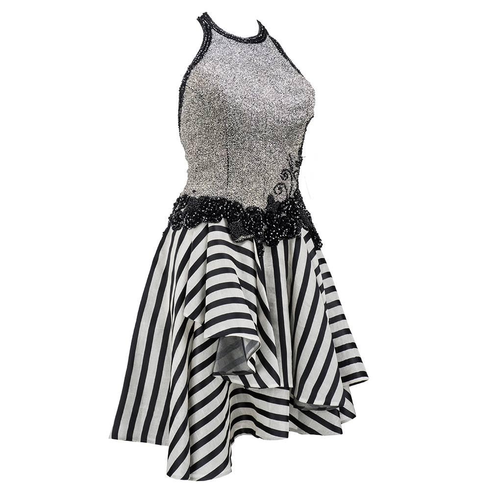 This is the perfect dress for a New Years Eve celebration! Fabrice is renowned for fabulous beadwork and sexy silhouettes. Featuring a beaded halter bodice with sexy low back, the dress has an asymmetrical candy striped, flouncy skirt. Zipper back.