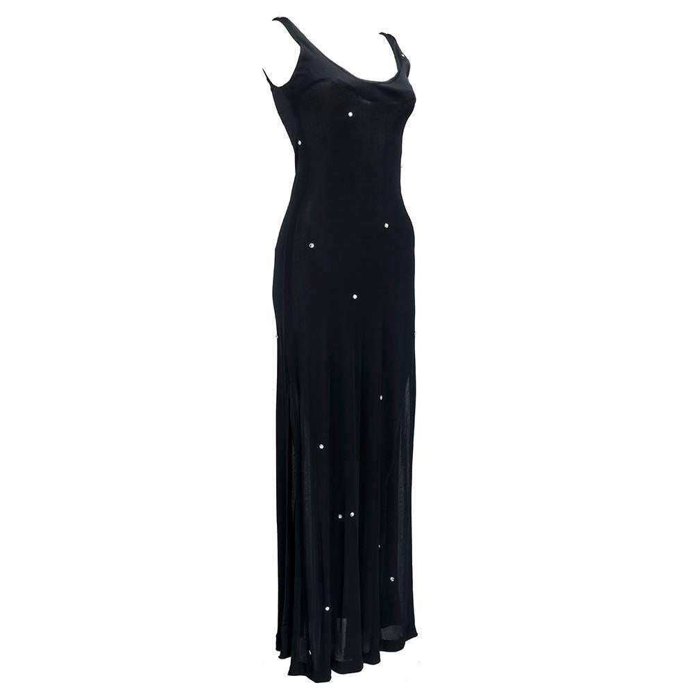 Fantastic, slinky silk jersey tank dress from Halston is decked with hand sewn Swarovski crystal accents. Lightweight jersey dress hugs the body with a low scoop neck and a slit up the side.