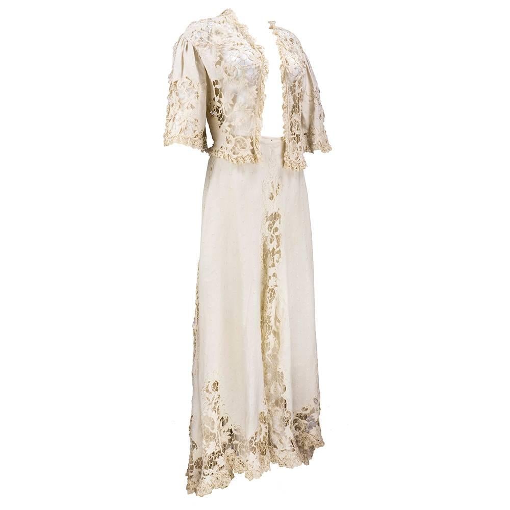 Fantastic Edwardian walking suit includes an ecru linen jacket with delicate cotton Battenburg lace. Linen is embroidered all over with monochromatic dots. Gathered sleeves are vented and trimmed with finely woven floral lace. Skirt is inset with