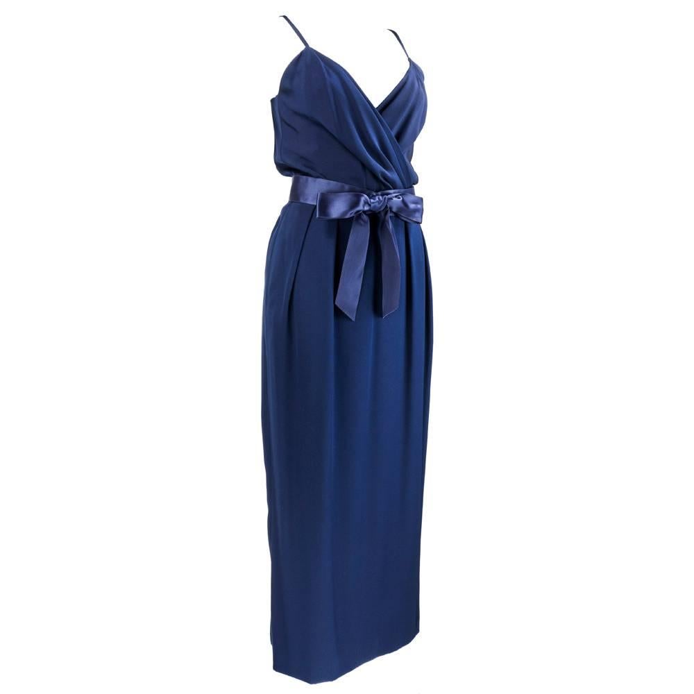 A silk wrap gown from Christian Dior couture, Printemps-Été 1984. Equal parts tailored and sexy, gown is accented by a feminine navy silk bow belt, and has accompanying tailored jacket. Jacket hooks in center.

Jacket-
Bust: 38 inches
Length: 20