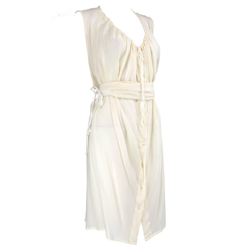 Classic Demeulemeester piece circa 1990s - white silk chiffon tunic style dress. With drawstring neckline, buttons down front and matching sash belt. Can be worn loose and flowing or belted. Adjustable self tie in back. Sheer, lightweight and