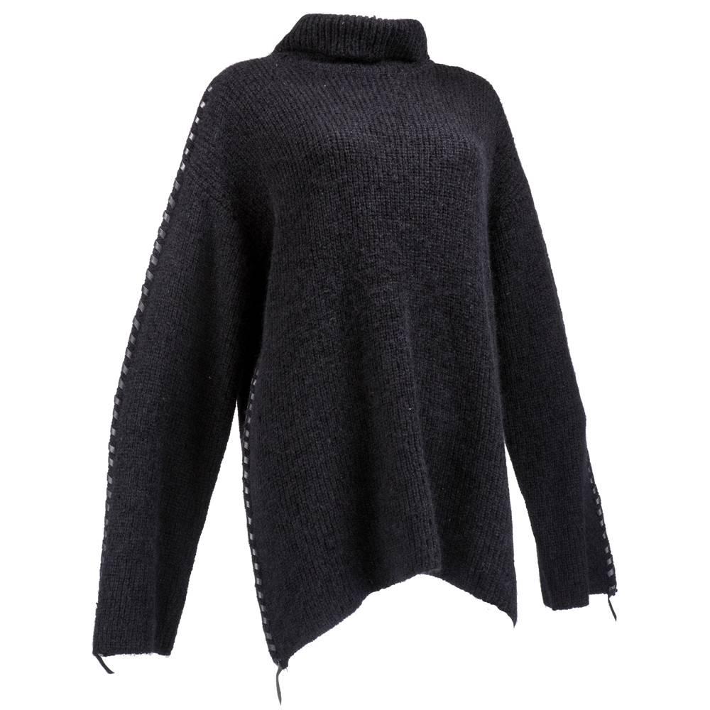 Cozy and chic long oversized sweater by Issey Miyake. Black wool rayon blend in thick chunky weave and black leather top stitching.  Feels hand knit and looks like it has never been worn.