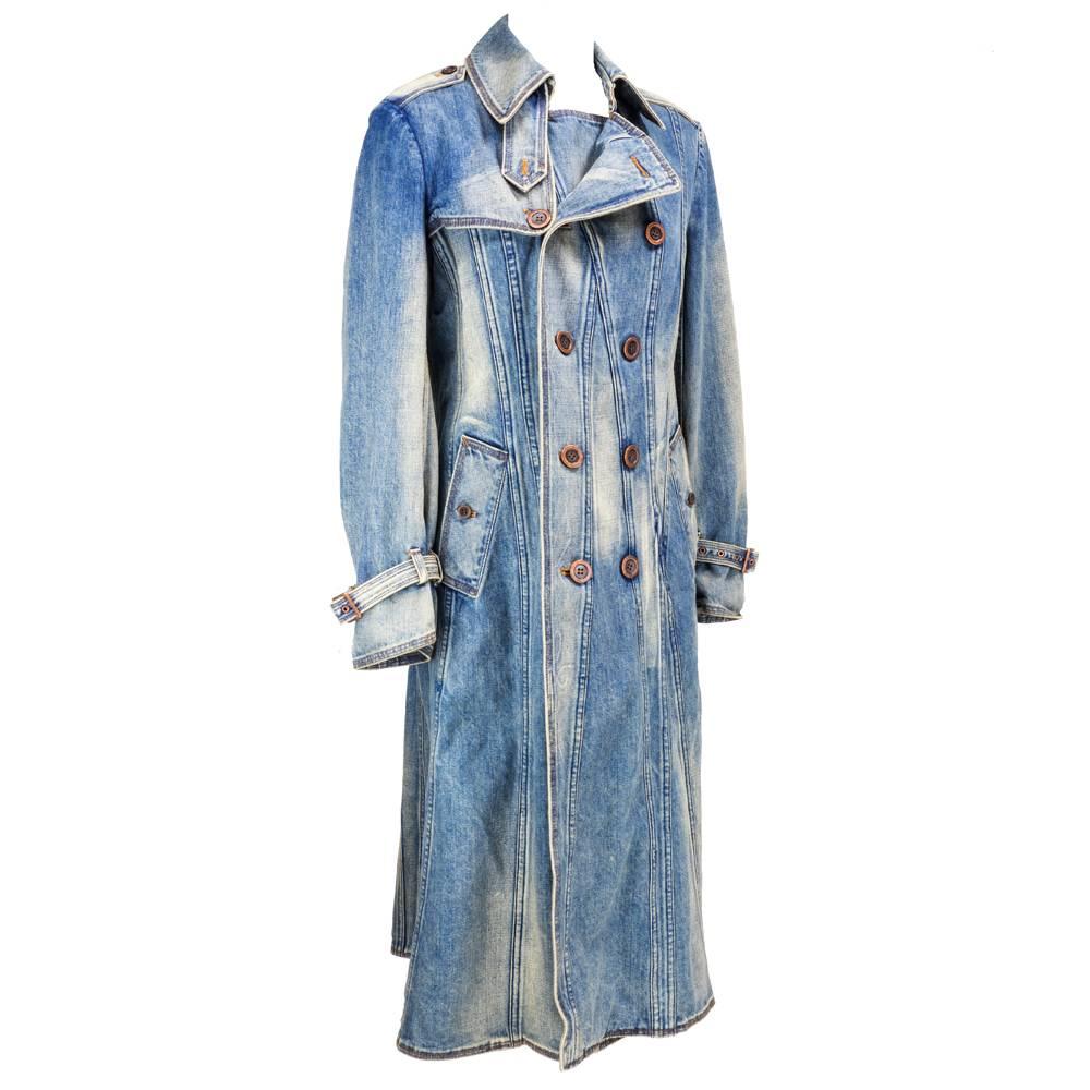 Super cool full length trench style coat in stone washed denim. Unlined with double breasted styling and long vent at rear.  Beautiful sculptural seaming.  Adjustable buckles at cuff. 100% cotton. Dated 2001.  Appears to have never been worn. 