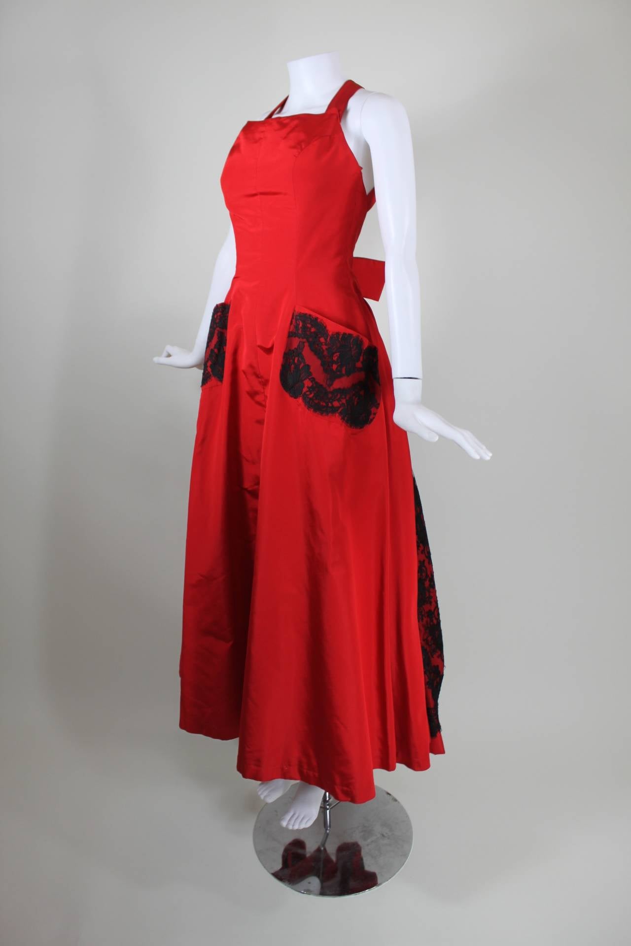 This is a gorgeous lipstick red two-piece pinafore gown from master of chic whimsy, Christian Lacroix.

Pinafore Measurements--
Bust: 32 inches
Waist: 26 inches
Hip: free

Ball Skirt Measurements--
Waist: 24 inches
Hip: free
Length, Waist