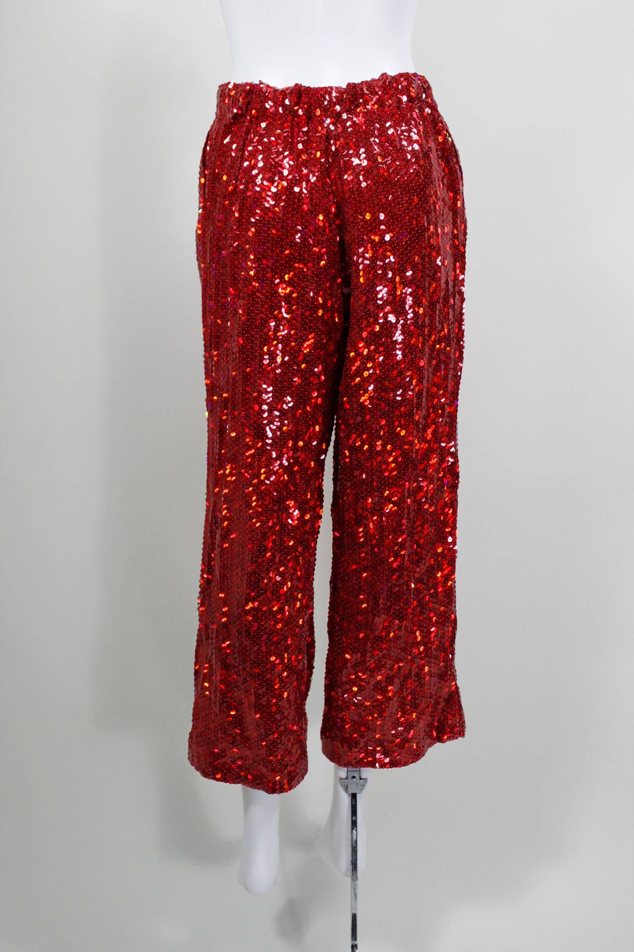 Comme des Garçons Fire Engine Red Sequined Cropped Pants

-Unlined
-Elastic waist

Measurements--
Waist: 27 inches, relaxed. 36 inches maximum.
Hip: up to 40 inches
Rise: 11 inches
Inseam: 25 inches
Total Length: 35 inches