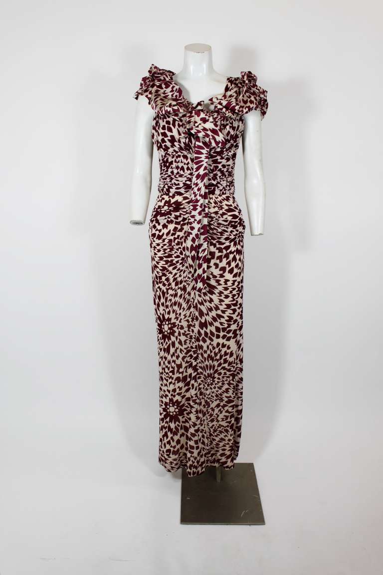 A lovely gown from Missoni, done in an abstract floral print ruched jersey. The silhouette is sexy and chic; it clings to the body in all the right places, has an elegantly plunging neckline, and has the optional ruffled wrap.

Measurements