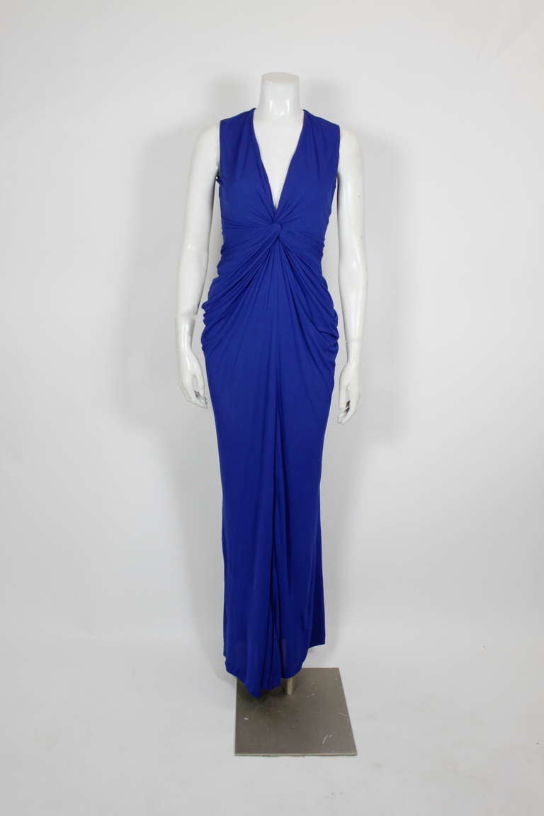 A dazzling blue ruched gown from Alexander McQueen. A lean and slinky silhouette makes this the ultimate sexy gown.

-Half lined from bodice to mid-thigh
-Zips in center back
-Slit in center front
-Labeled Size 40

Measurements--
Bust: 36