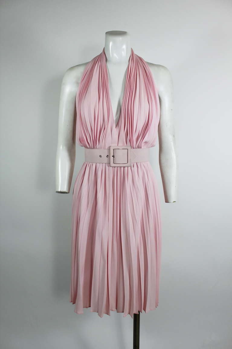 A flirty and fabulous blush pink pleated dress from YSL. A halter neck, cinched waist, and full skirt come together to make the perfect summer cocktail dress.
-Labeled size 38
-Bodice is lined

Measurements--
Bust: up to 36 inches
Waist: 26