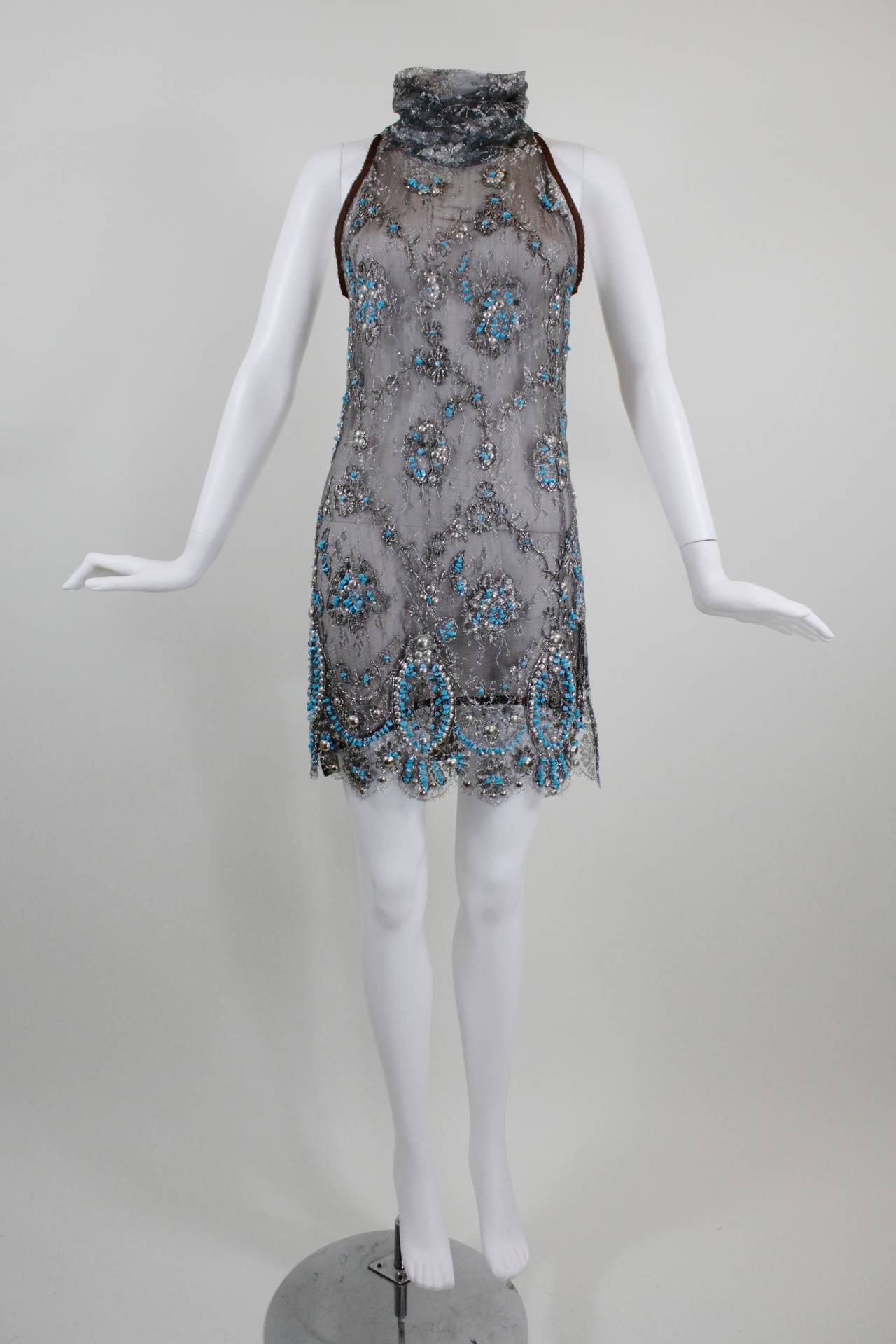 This is a beautiful tabard-style micro-mini dress from Gianfranco Ferre--the ultimate sexy cocktail frock! Charcoal and silver metallic lace lay over a taupe silk lining. The lace is embroidered with silver metallic thread, and features silver