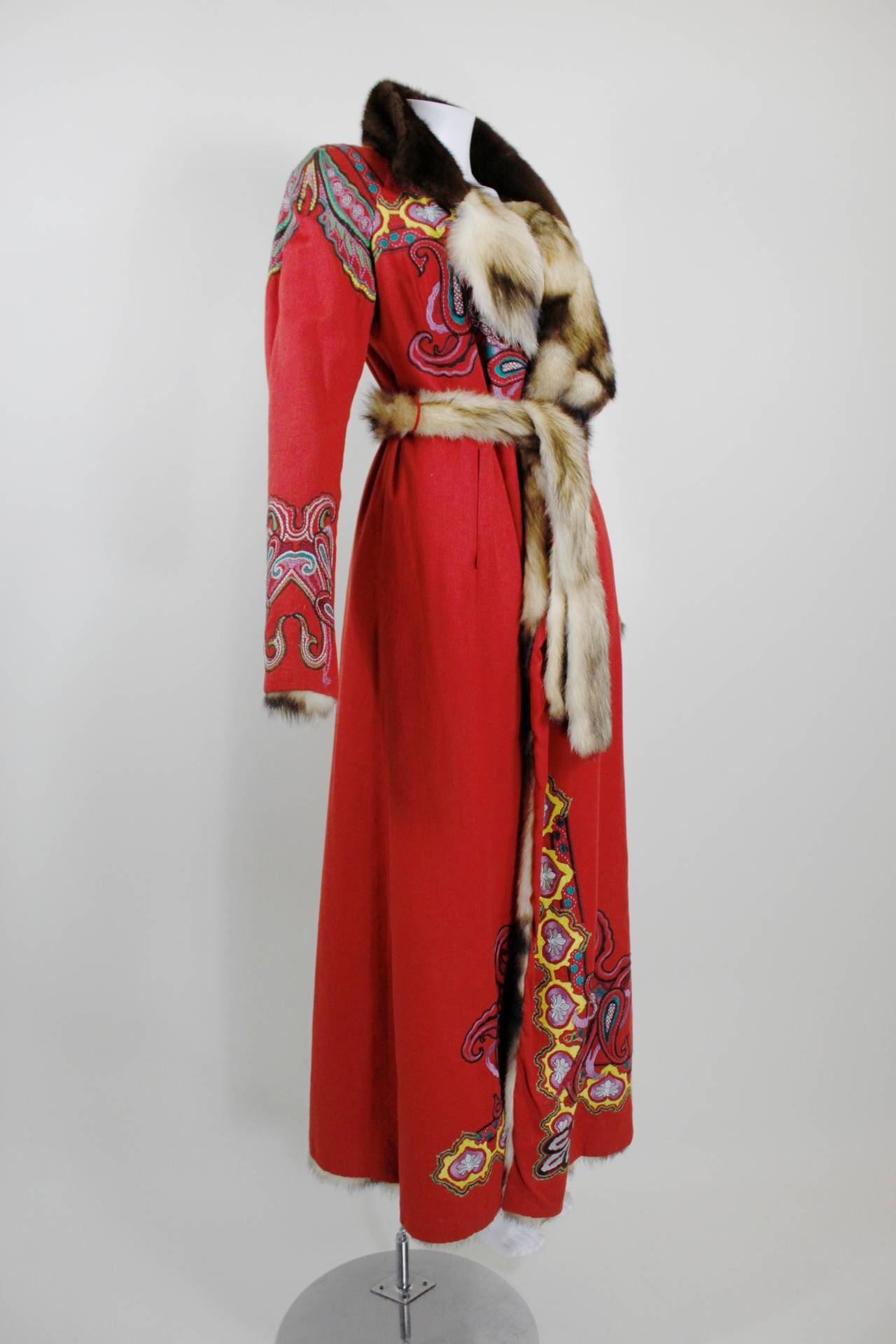 A jaw-dropping, never-been-worn coat from Christian Lacroix. One side of the coat features lipstick red cotton-wool with vibrant rainbow embroidery throughout, and a mink collar. The coat can be reversed into a full fur coat (the red embroidered