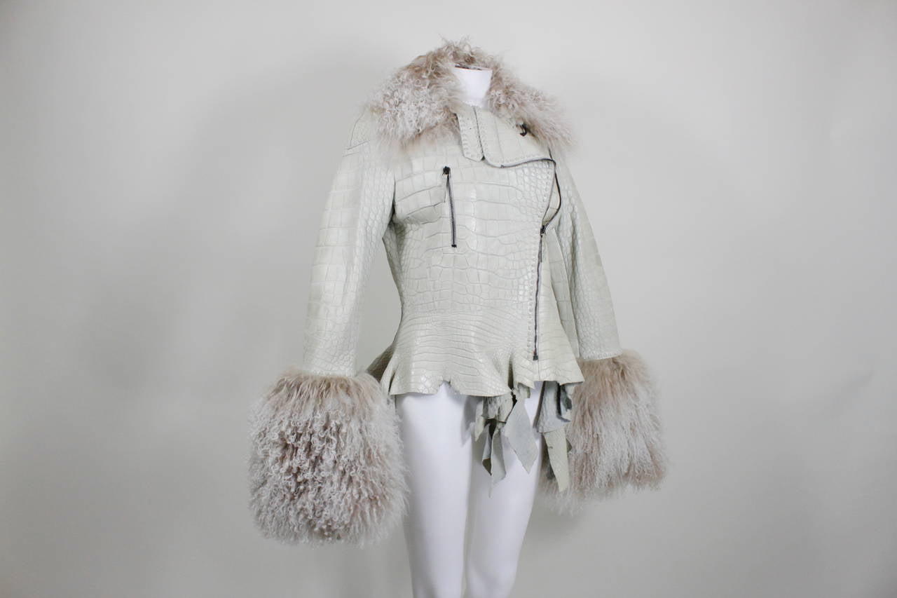 A fabulous moto-style jacket from Ungaro done in embossed icy eggshell leather and trimmed with cascading Mongolian fur.

Measurements--
Bust: up to 36 inches
Waist: up to 32 inches
Sleeve Length: 29 inches
Shoulder to Shoulder: 18 inches
