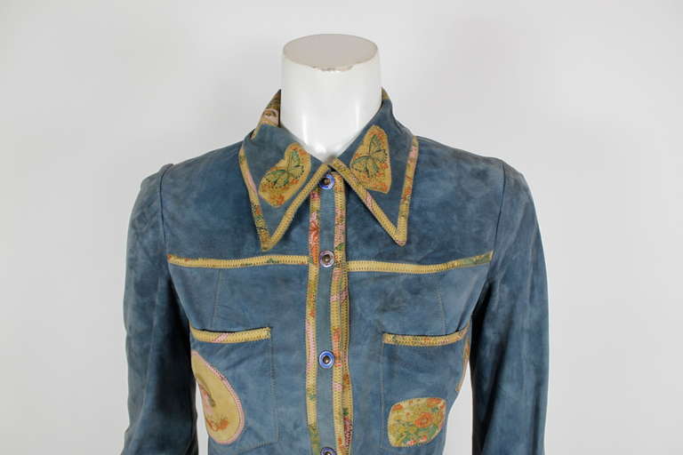 Early and rare Cavalli piece. Short, but not cropped, jacket stops at natural waist. Patchwork appliqués at front pockets, collar, and cuffs. Snap button closure. Buttons at cuffs.
