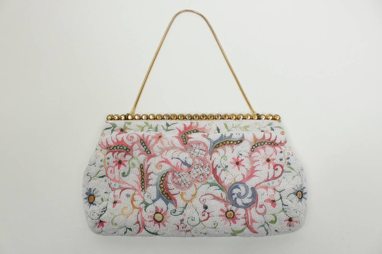 A lovely evening bag from Josef, featuring the most stunning embroidery and beading. Lovely pastel shades of tambour-stitch embroidery create an almost Asian floral motif. Lightly pearlescent beads create a soft, textured background. The purse is