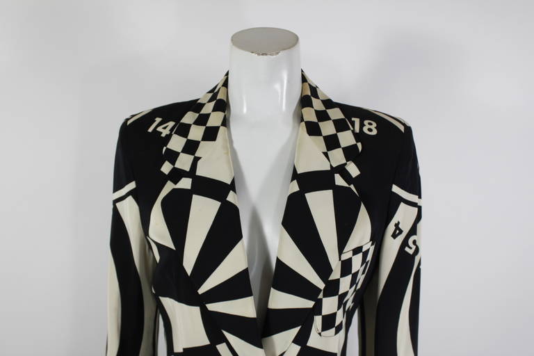 A contrasting bullseye print is the focus of this Moschino Cheap & Chic op-art skirt suit. Checkerboard lapels and waistband accent the bullseye print with a heart in the middle. Fully lined. Skirt zips in back. Jacket measurements below, skirt