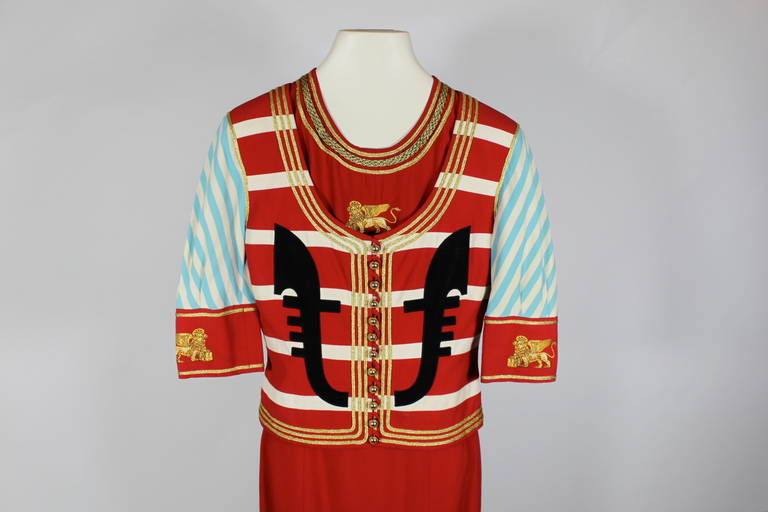 With a nod to officer's motif, the cropped jacket is multi-colored with gold ball buttons, gold piping and embellishments, fitted dress in solid red. Dress measurements below, jacket measurements as follows: 
Bust: 32”  
Waist:  27”
Length: