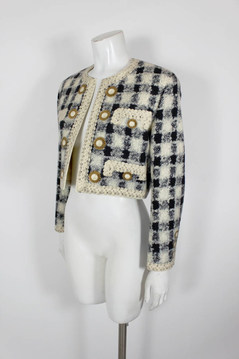 A witty alternative to Chanel’s iconic tweed suit, the Moschino bouclé printed jacket is a perfect fit. Oversized pearl buttons. Pockets at bust. 
 