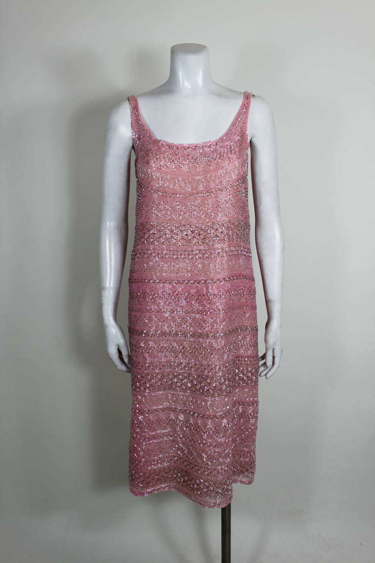 A beautiful shimmering party dress from Halston. Varying shades of pink bugle beads on silk organza add a geometric pattern and texture to the dress.  Intact beading. Slip-on style; no zipper. Includes original slip.
