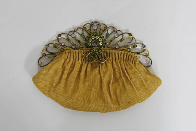 An extraordinary canary yellow Josef beaded evening bag with am Hobé closure. The closure suggests a fantastic peacock-like quality and features vibrant green, yellow, and milky opal-esque stones. It is an absolutely stunning work of art!
